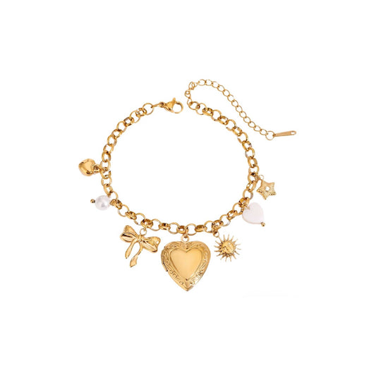 Gold pearl heart charm bracelet with elegant pearls, playful heart charms, and a 17.5cm chain length.