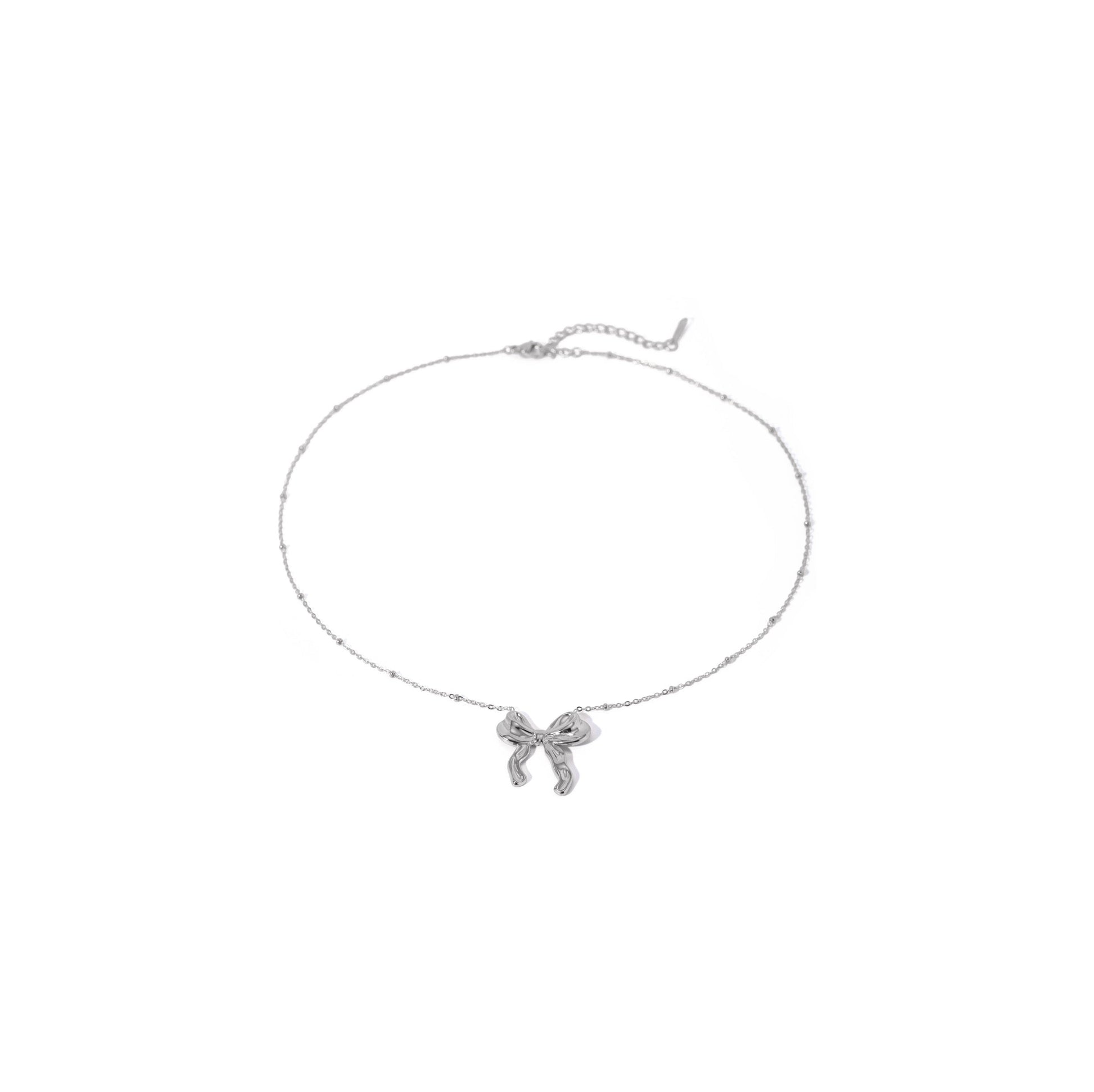 Silver bow ball chain necklace with delicate bow design and trendy ball chain.