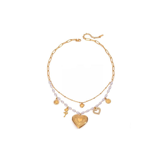 Gold pearls and hearts charm necklace featuring delicate pearls and playful gold charms on a double-layered chain.
