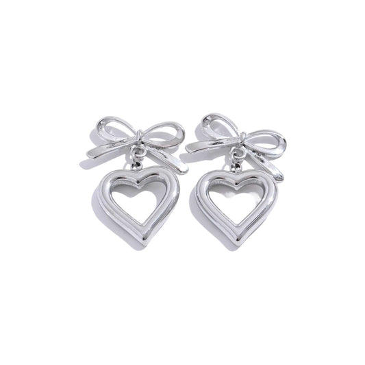 Silver bow heart drop earrings with playful bow and heart design.