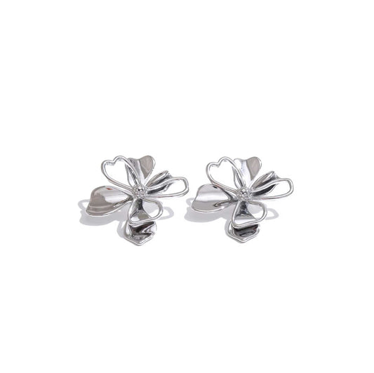 Silver flower cutout earrings with whimsical design.
